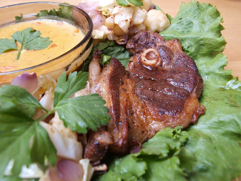 Closeup Lamb Chop On Salad Bed With Gravy Picture. Image 9839474