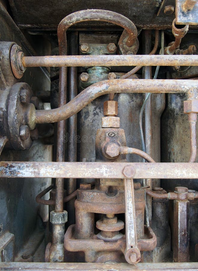 Close up of a large old abandoned marine diesel engine showing rusting pipes and cylinders and bolts royalty free stock image Close up of a large old abandoned marine diesel engine showing rusting pipes and cylinders and bolts royalty free stock image