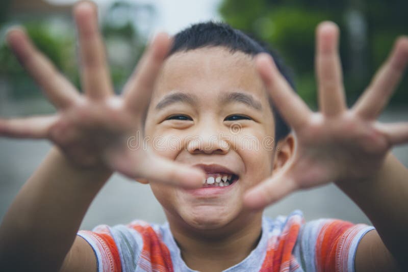 Close up laughing face of asian children playing with happiness emotion