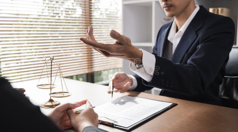 Close-up of lawyer and businesswoman signing legal documents of doing business in lawyer& x27;s office room stock photography