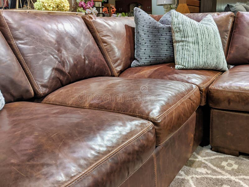 Close Up of a Leather Sectional Covered with Pillows Stock Image