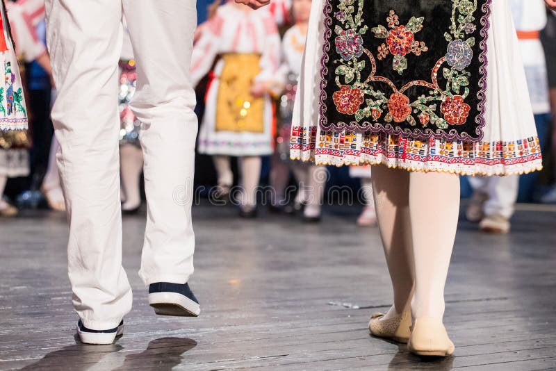 Close up of legs of young Romanian dancers perform a folk dance in traditional folkloric costume. Folklore of Romania royalty free stock image Close up of legs of young Romanian dancers perform a folk dance in traditional folkloric costume. Folklore of Romania royalty free stock image