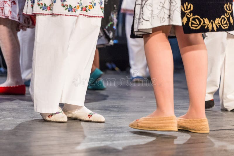 Close up of legs of young Romanian dancers perform a folk dance in traditional folkloric costume. Folklore of Romania royalty free stock photos Close up of legs of young Romanian dancers perform a folk dance in traditional folkloric costume. Folklore of Romania royalty free stock photos