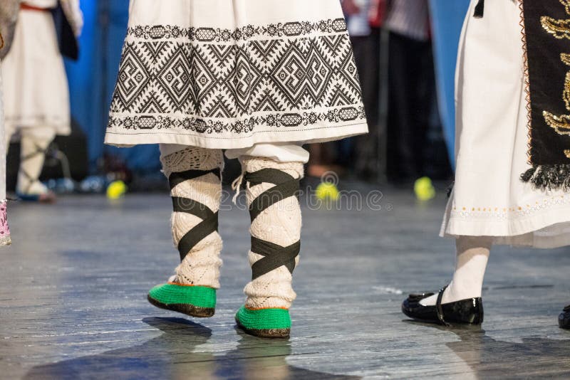 Close up of legs of young Romanian dancers perform a folk dance in traditional folkloric costume. Folklore of Romania stock photos Close up of legs of young Romanian dancers perform a folk dance in traditional folkloric costume. Folklore of Romania stock photos