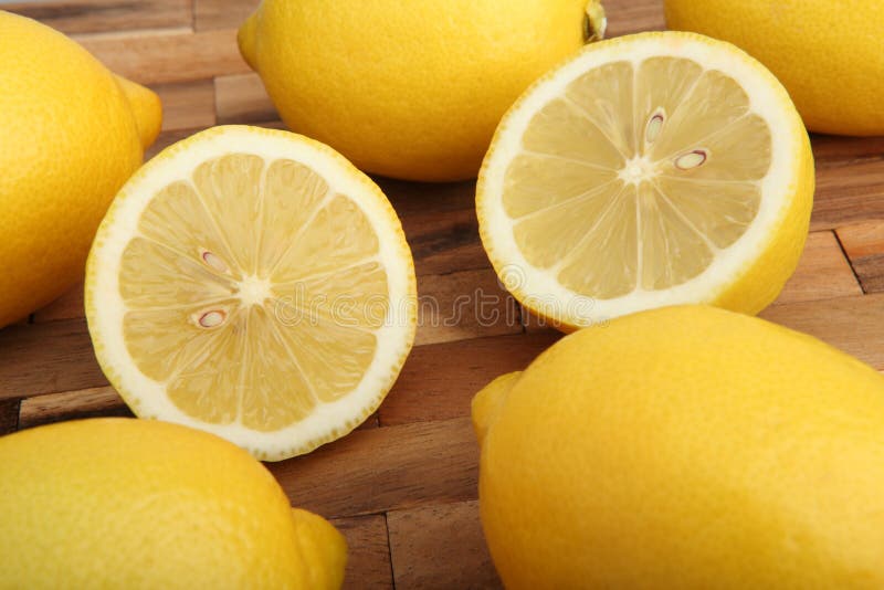 Close-up of lemons on wooden pad in the studio