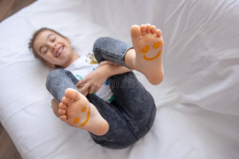 Close Up Of Little Girls Feet Painted With Smiles Stock Photo Image