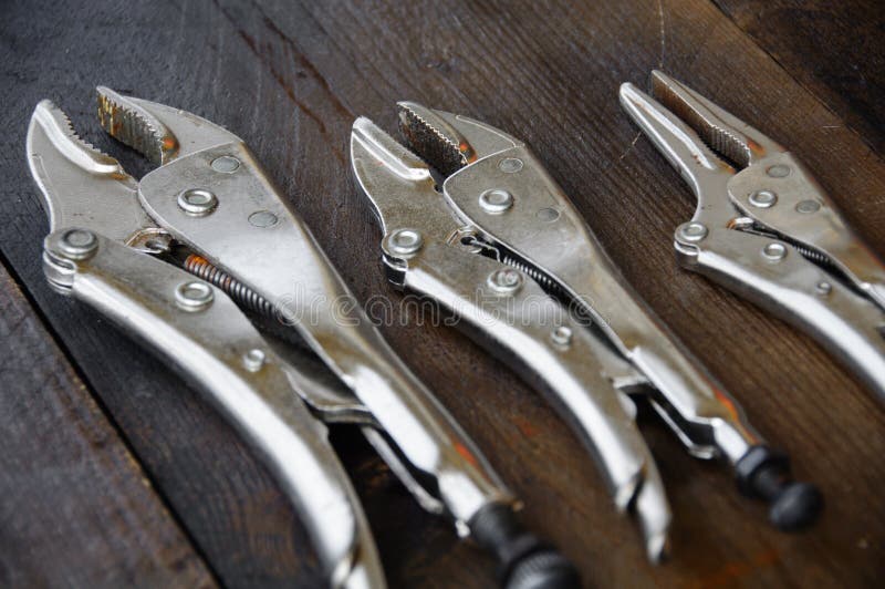 Close up locking pliers on wooden background, Hand tools in work shop stock photography