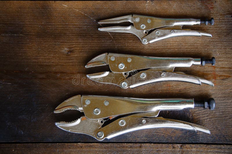 Close up locking pliers on wooden background, Hand tools in work shop royalty free stock photography