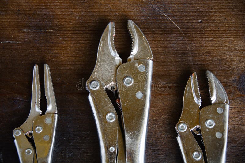 Close up locking pliers on wooden background, Hand tools in work shop stock images