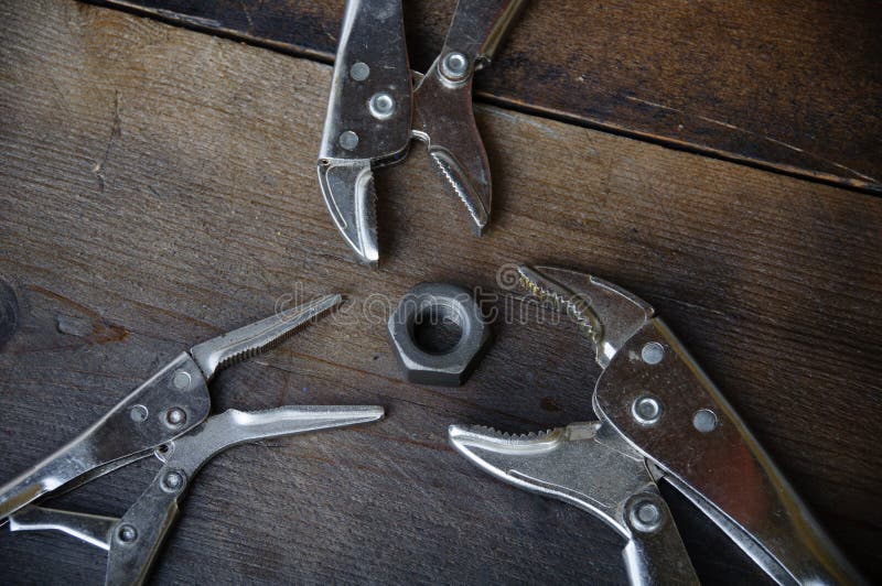 Close up locking pliers on wooden background, Hand tools in work shop royalty free stock photography