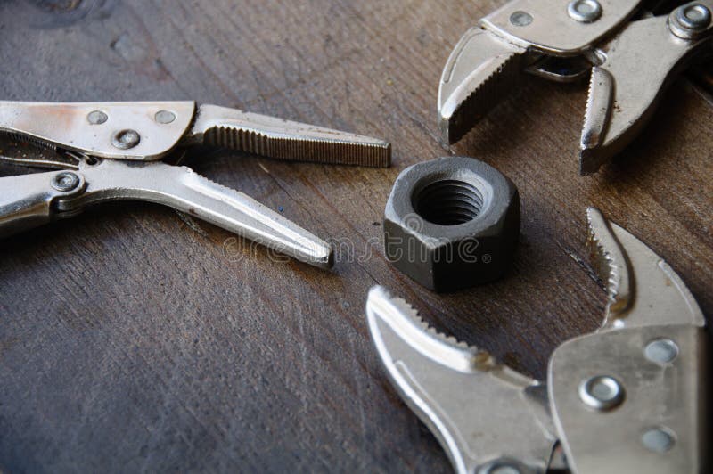 Close up locking pliers on wooden background, Hand tools in work shop stock images