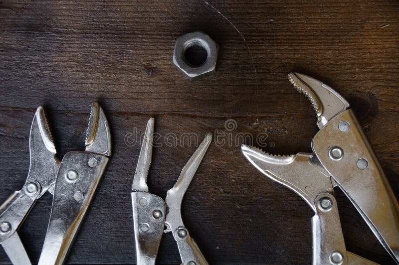 Close up locking pliers on wooden background, Hand tools in work shop stock photos