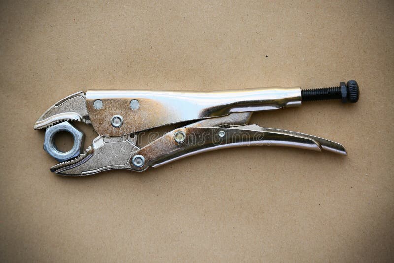 Close up locking pliers on wooden background, Hand tools in work shop royalty free stock image