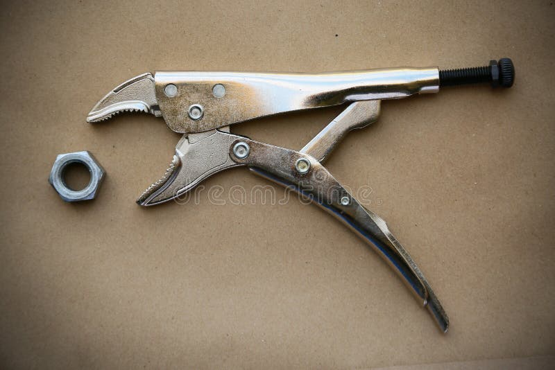 Close up locking pliers on wooden background, Hand tools in work shop stock image