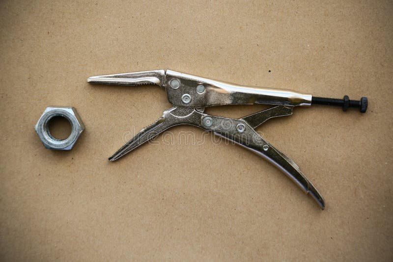 Close up locking pliers on wooden background, Hand tools in work shop stock photo