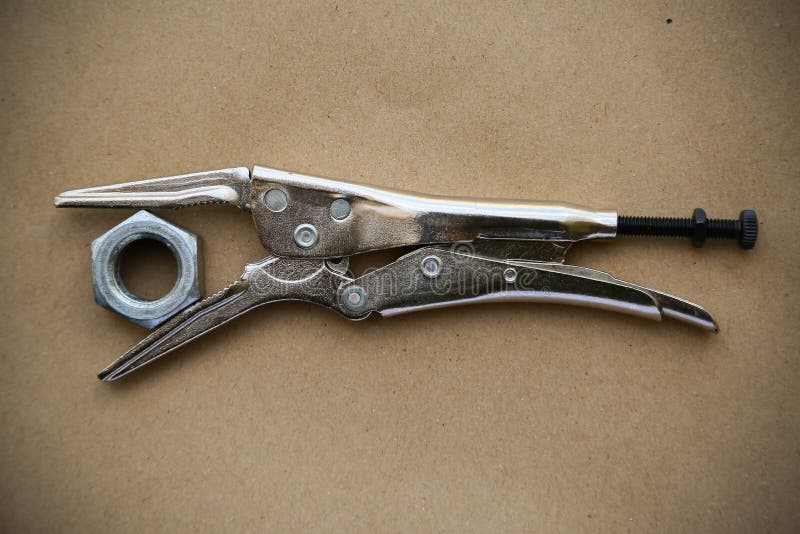 Close up locking pliers on wooden background, Hand tools in work shop stock images