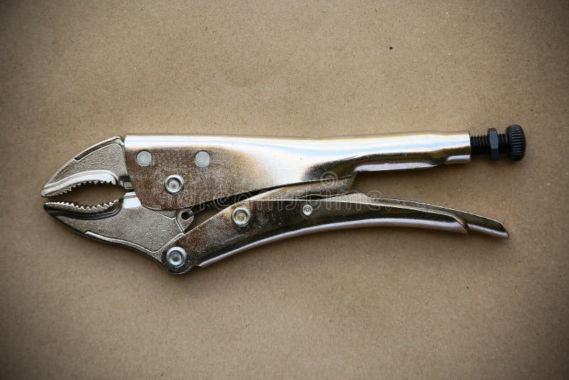 Close up locking pliers on wooden background, Hand tools in work shop royalty free stock photo