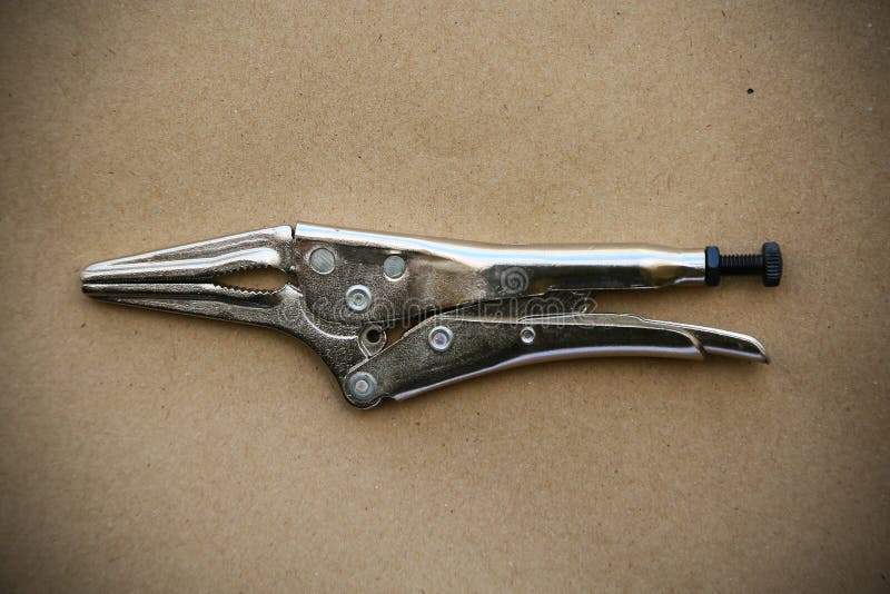 Close up locking pliers on wooden background, Hand tools in work shop stock photo