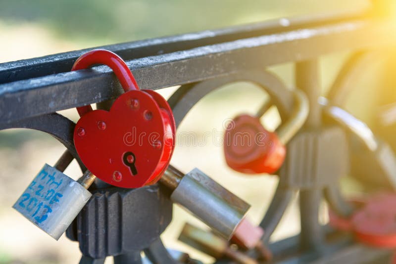 Close-up on locks of hearts in different colors and shapes hanging on the fence as a sign of eternal love, which is hung during royalty free stock photos Close-up on locks of hearts in different colors and shapes hanging on the fence as a sign of eternal love, which is hung during royalty free stock photos