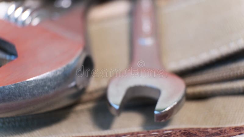 Close-up of locksmith`s tool - adjustable wrenches in a canvas bag pocket on a rotating table. stock footage