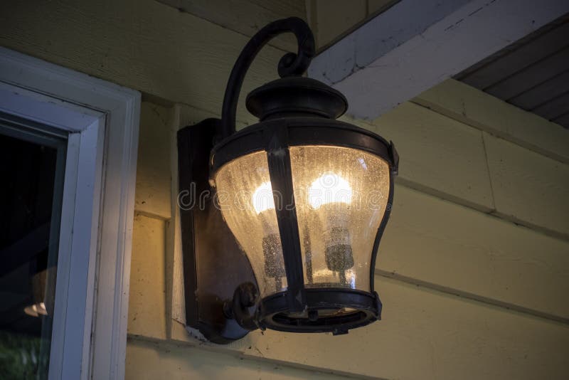 Close up, low angle view of an old fashioned lantern on a porch stock image