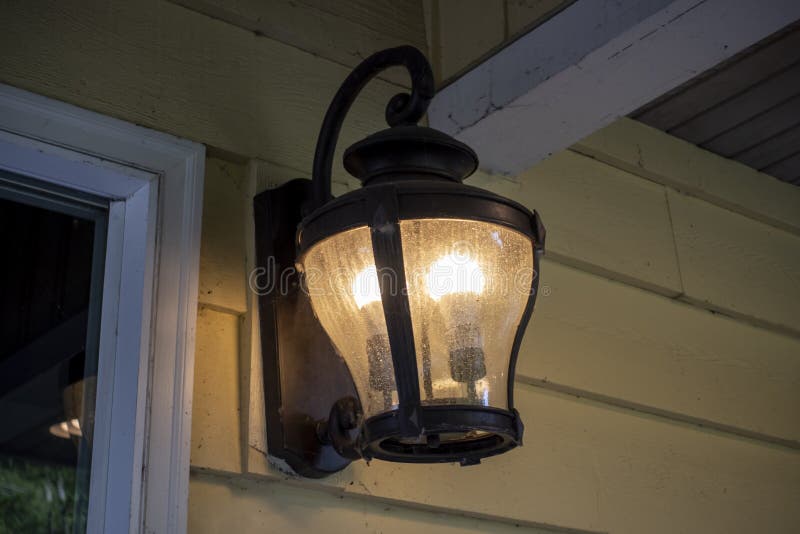 Close up, low angle view of an old fashioned lantern on a porch royalty free stock image
