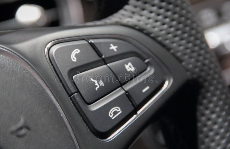 The Close Up of Luxury Car Steering Wheel Command Buttons. Stock Photo