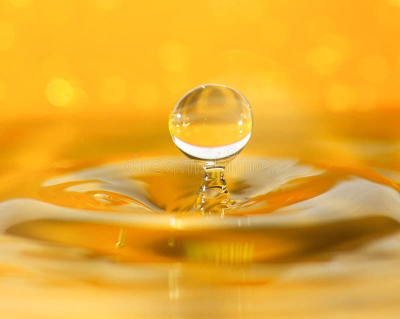 Water drop macro closeup on orange background. Water drop macro closeup on orange background