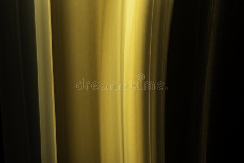 A close up macro photo of a vertical wisp of orange smoke on a black background that makes an abstract artistic retro background