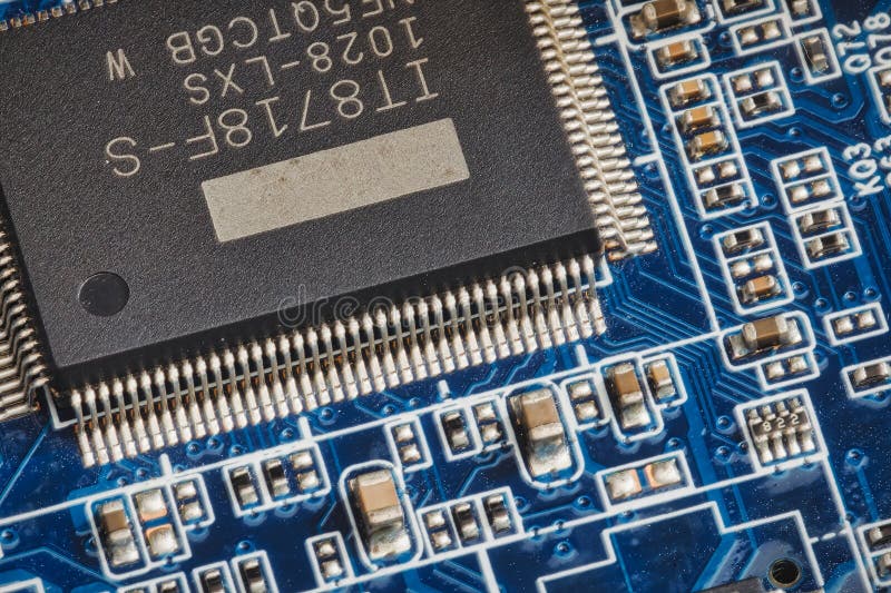 Close-up shot of a blue circuit board with electrical components and microchip stock image