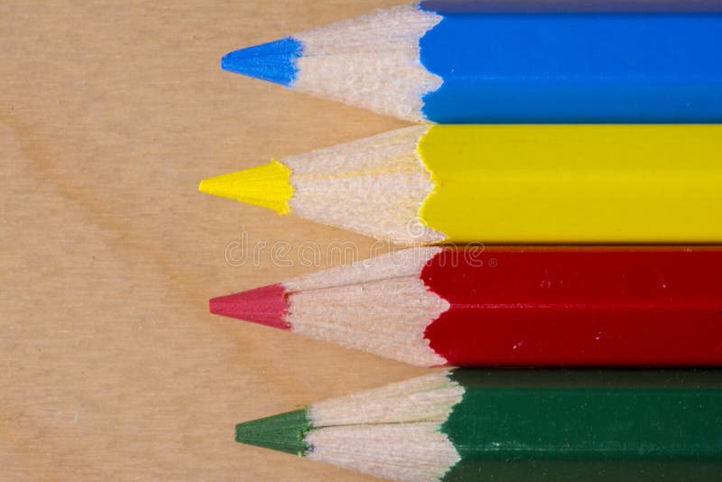 Close up macro shot of horizontal yellow, red, blue and green color pencil