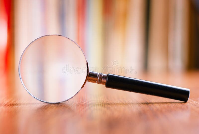 Close up Magnifying Glass Leaning on Wooden Table royalty free stock photos Close up Magnifying Glass Leaning on Wooden Table royalty free stock photos