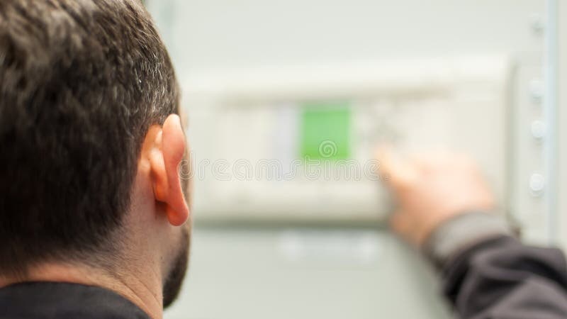 Close up of maintenance engineer testing voltage switchgear stock image