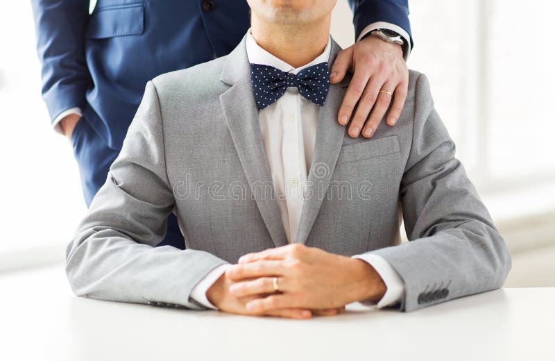 Close up of male gay couple with wedding rings on