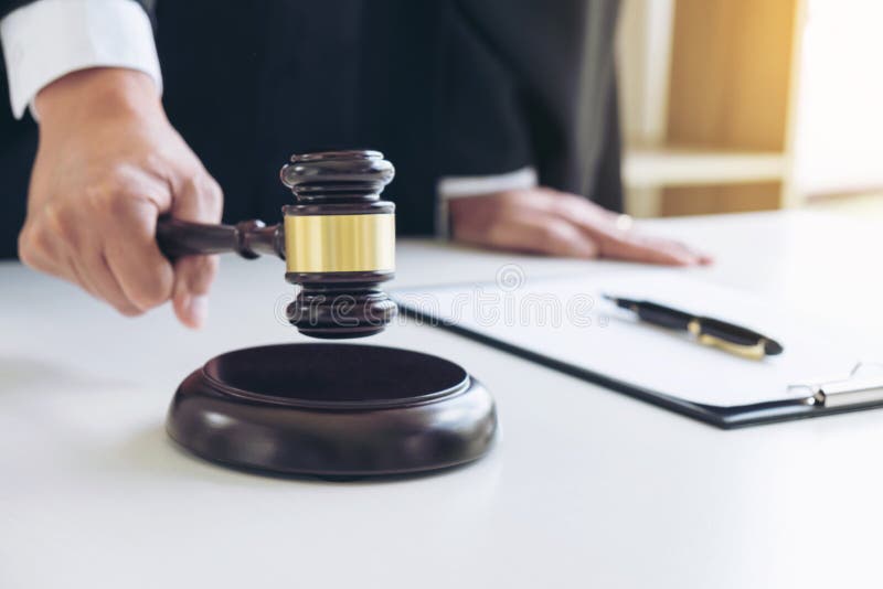 Close up of Male lawyer or judge hand's striking the gavel on so stock image Close up of Male lawyer or judge hand's striking the gavel on so stock image