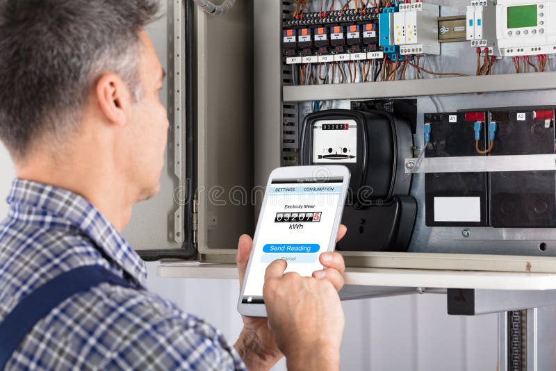 Technician Doing Meter Reading Using Mobilephone stock photos Technician Doing Meter Reading Using Mobilephone stock photos