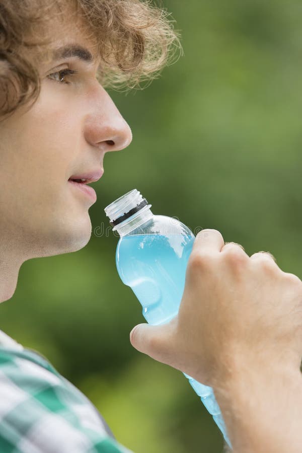Close-up of man drinking energy drink outdoors