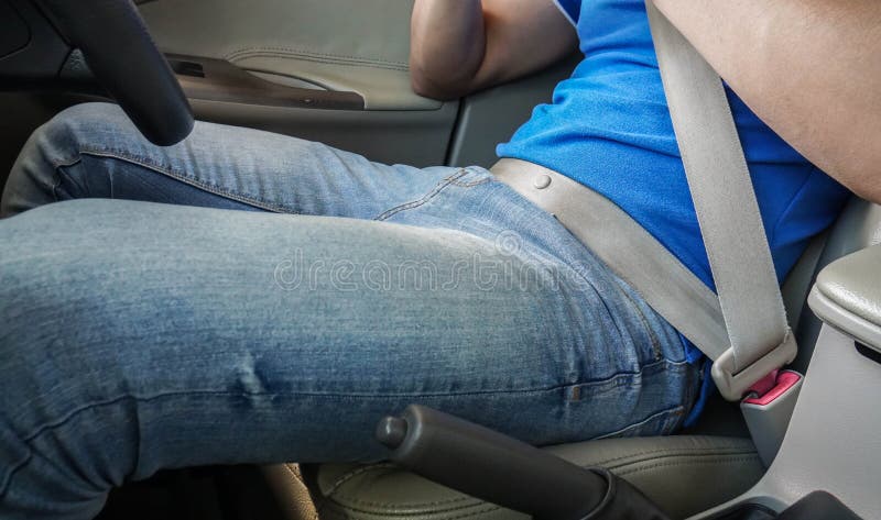 Man fasten seat belt while driving for safety.