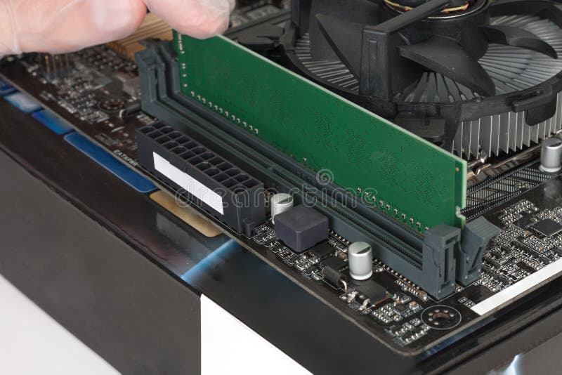 Close up of man hand with glove installing Ram DDR4 memory module in slot on motherboard royalty free stock images Close up of man hand with glove installing Ram DDR4 memory module in slot on motherboard royalty free stock images