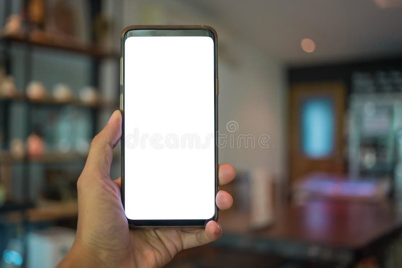 Close up of man hand holding mobile phone with white mock up blank copy space for your text message in cafe with colorful lamp royalty free stock photos.