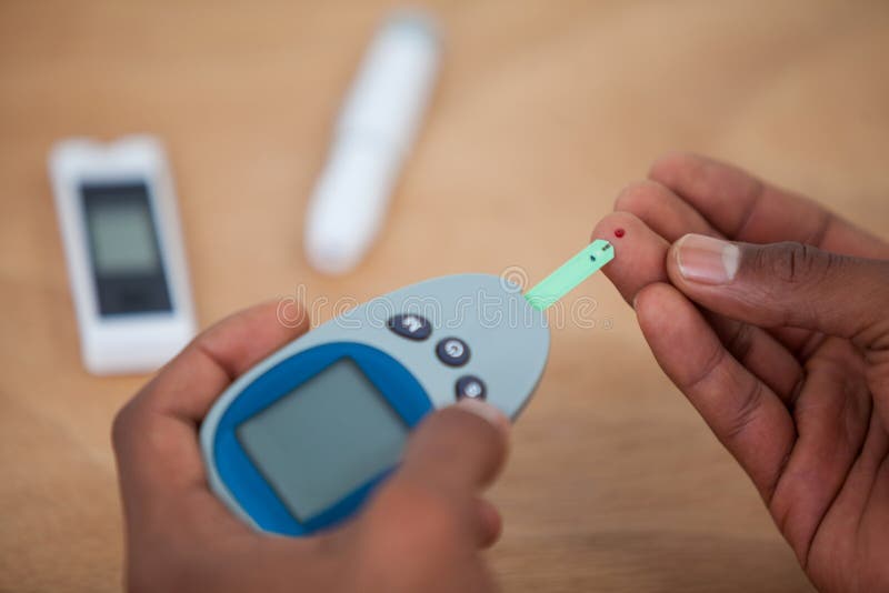 Closeup of Man Hands Testing Blood Sugar with Stock Photo