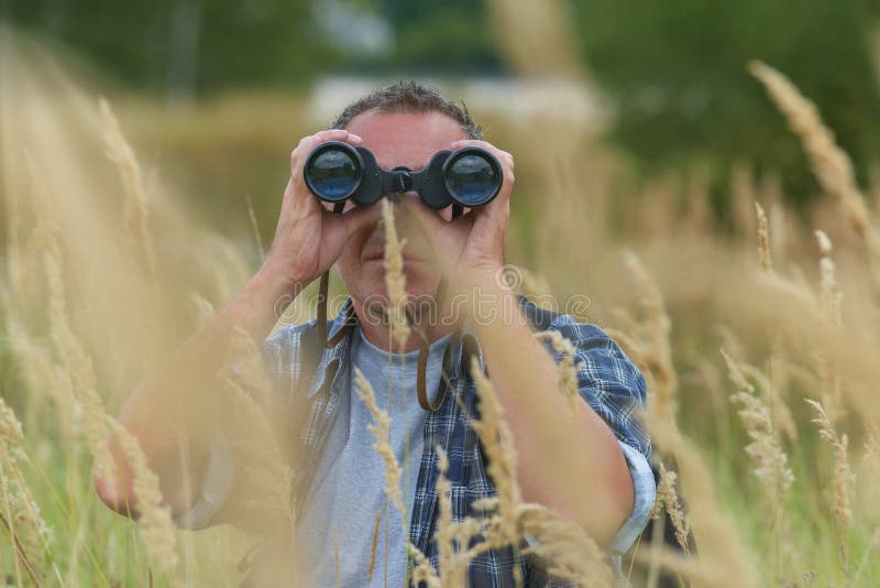Man looking through binocular royalty free stock images