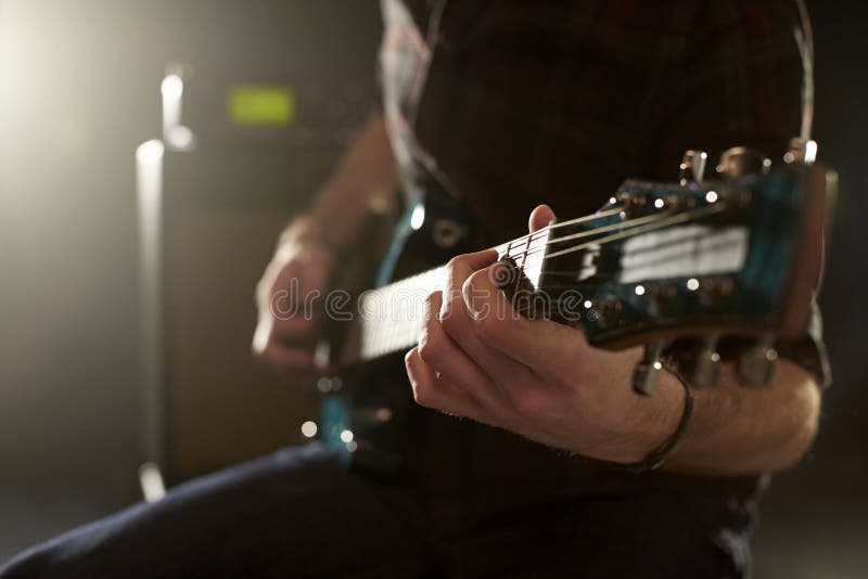 Close Up of Man Playing Electric Guitar in Studio Stock Photo Image