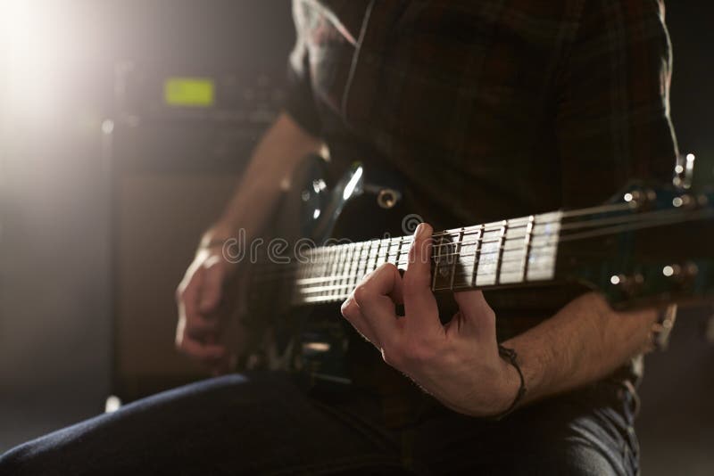 Close Up of Man Playing Electric Guitar in Studio Stock Photo Image