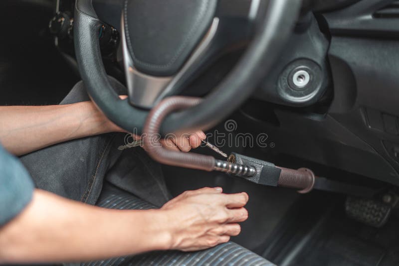 Close up of man use key locking steering wheel for security, Anti thief steal a car, Selective focus stock photos