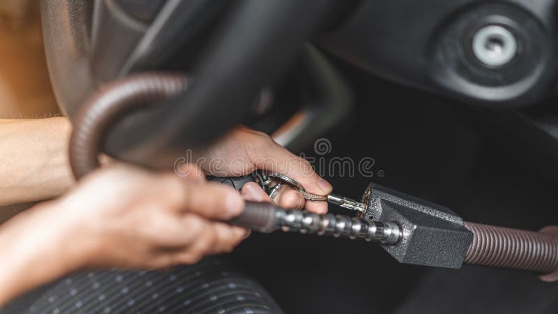 Close up of man use key locking steering wheel for security, Anti thief steal a car, Selective focus stock images