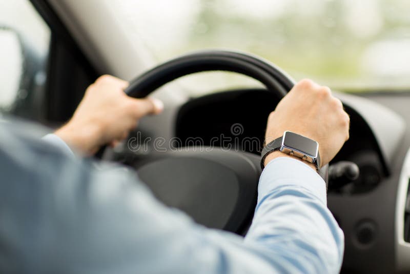 Close up of man with wristwatch driving car