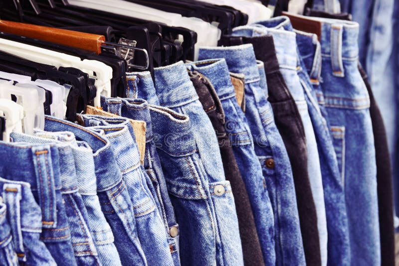 Many Jeans Hanging On A Rack. Row Of Pants Denim Jeans Hanging In ...