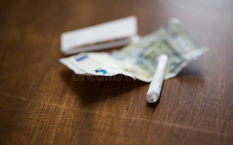 Close up of marijuana joint and money stock photos Close up of marijuana joint and money stock photos
