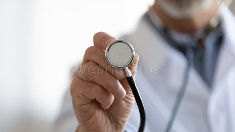 Close up mature doctor holding stethoscope, medical checkup. Equipment, senior therapist practitioner gp ready to examine lings or heart sounds, healthcare and